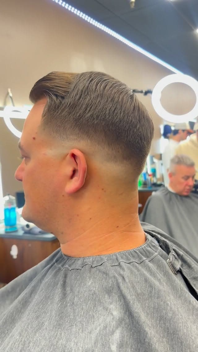 Client receiving a fresh cut at The Men's Room